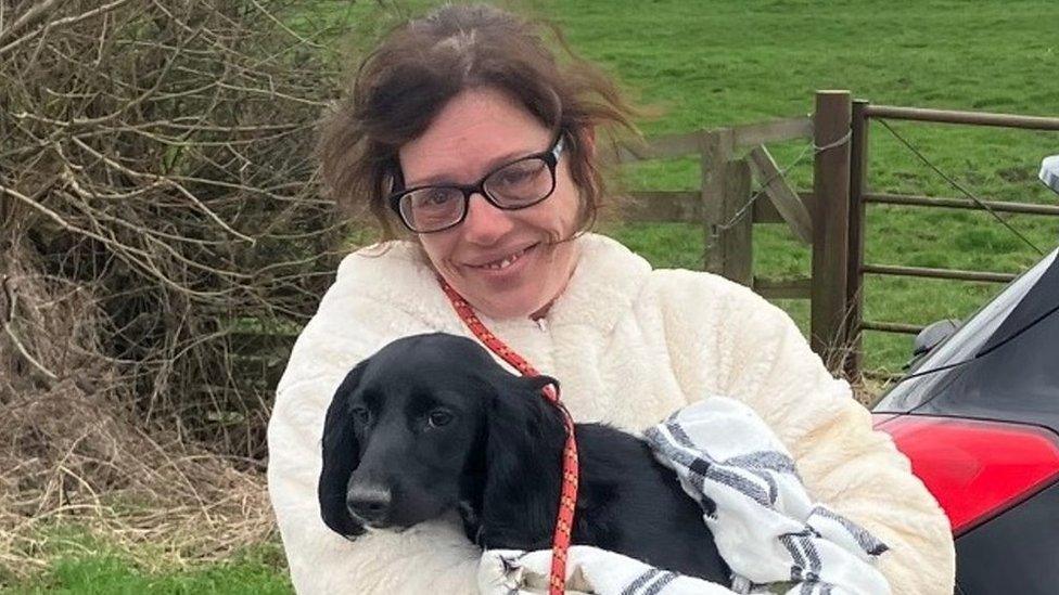 A woman holding her rescued dog