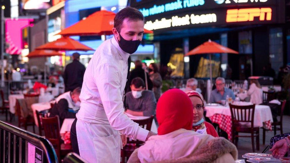 Waiter serving diners at Times Square