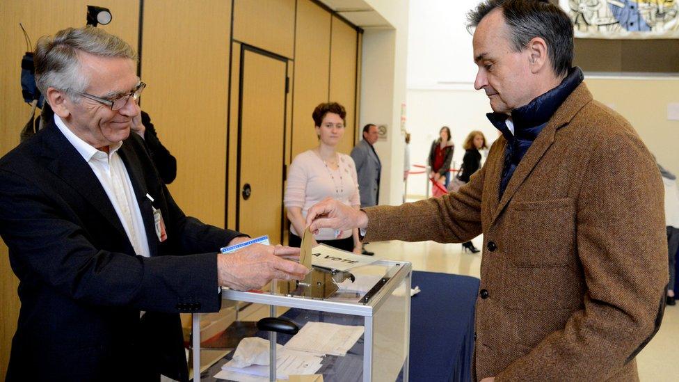 French Ambassador to the U.S. Gerard Araud (R) casts his ballot as he joins French citizens living in the United States voting in the French presidential run-off between Emmanuel Macron and Marine Le Pen, at the French Embassy in Washington, U.S., May 6, 2017.