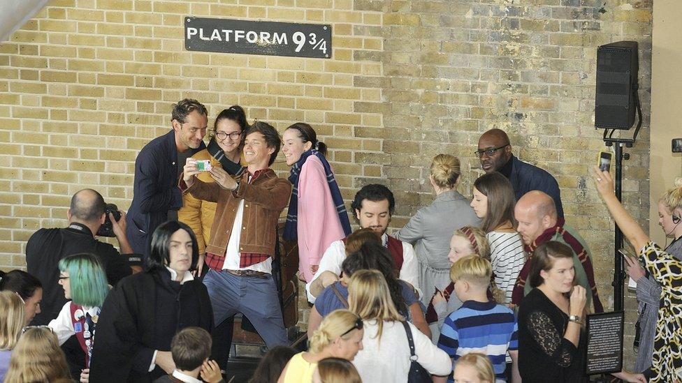 Fans taking a selfie with Eddie Redmayne and Jude Law.