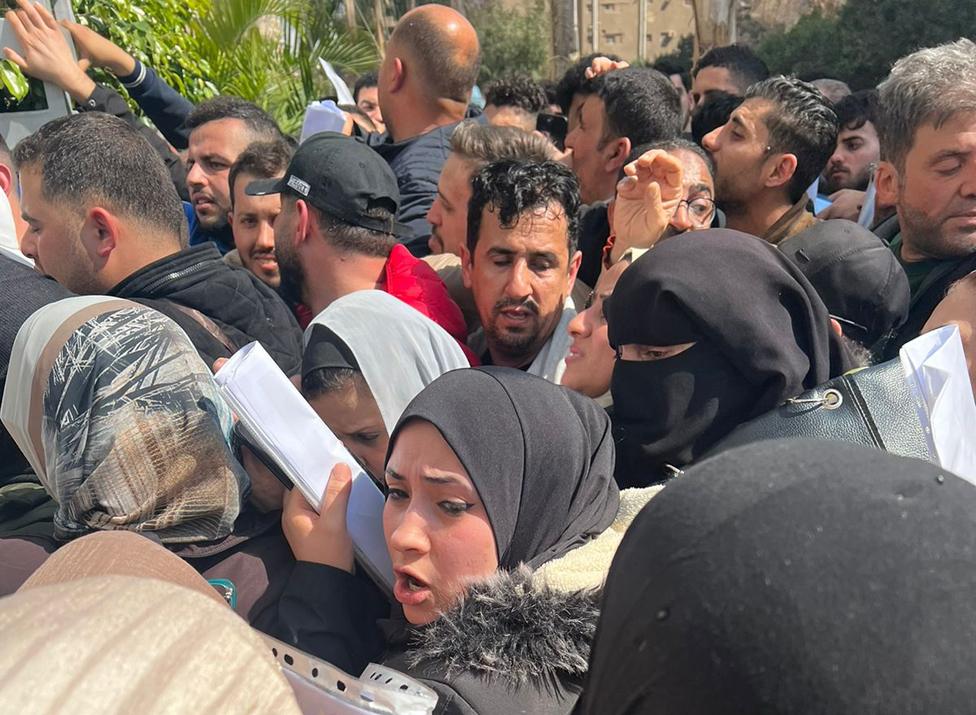 People crowd outside Hala offices in Cairo