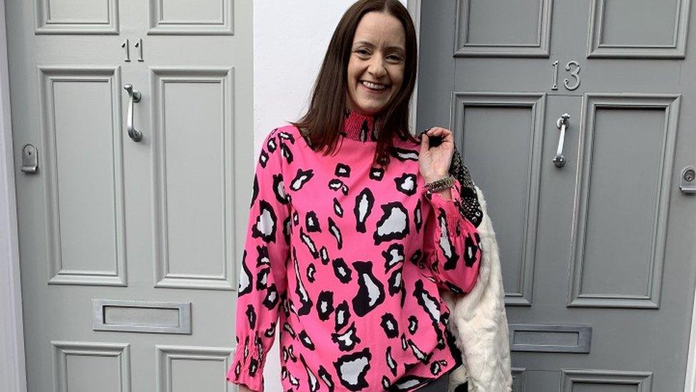 Fashion blogger Katie Kay wearing a neon pink jumper