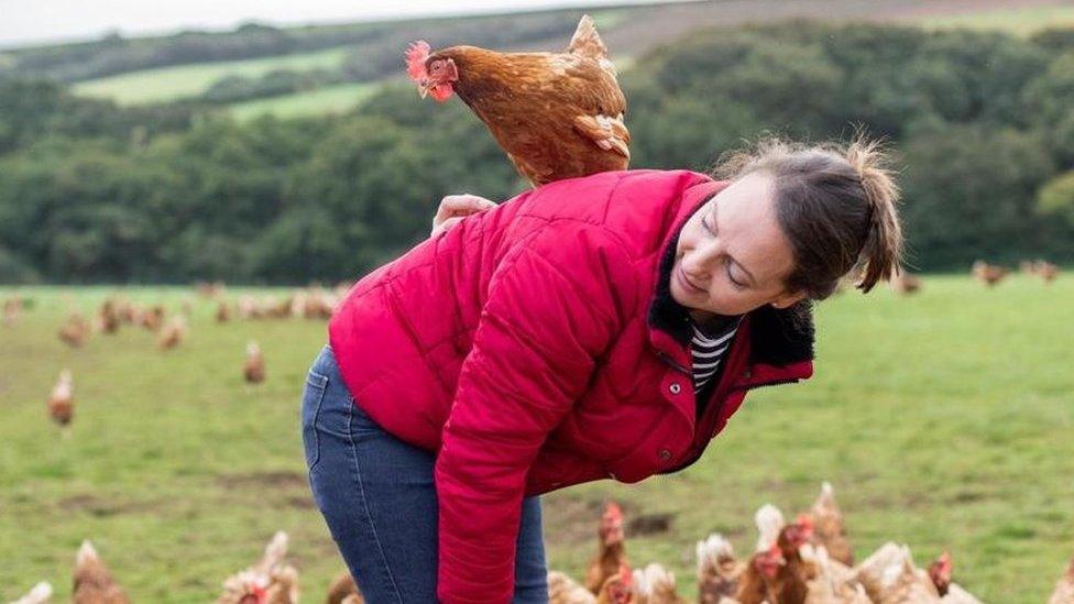 Bex Tonkin surrounded by hens