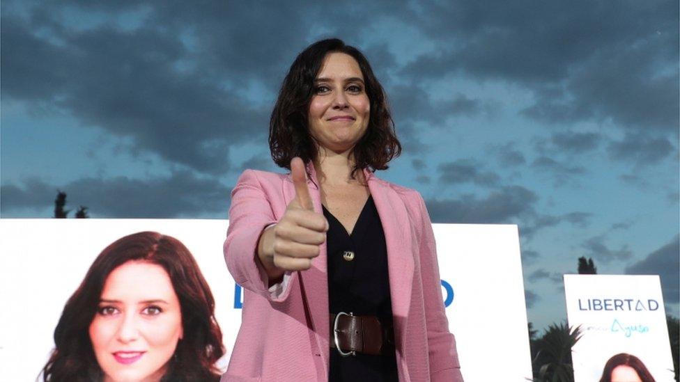 Isabel Díaz Ayuso gives the thumb up at the end of a final electoral campaign meeting ahead of Madrid's regional elections