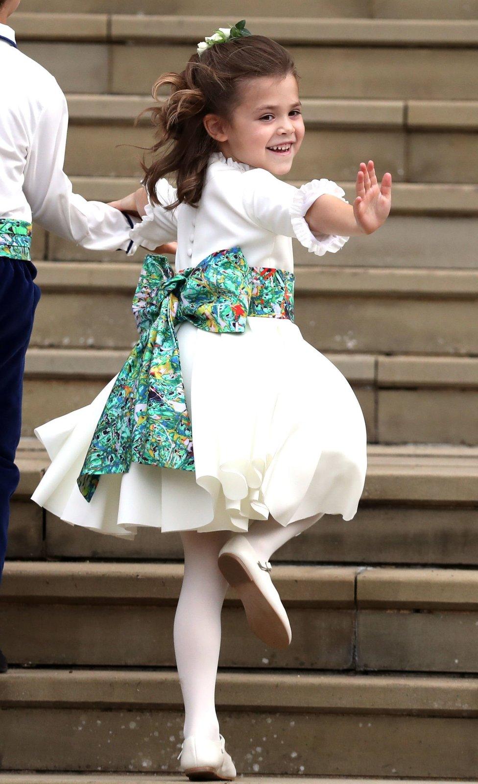 Theodora Williams, daughter of Robbie Williams and Ayda Field, waves outside St George's Chapel