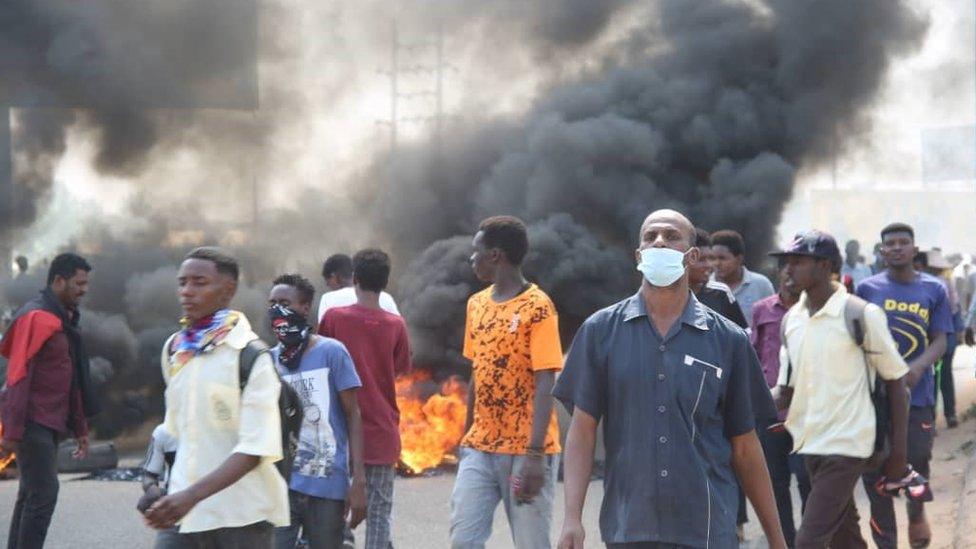 People protest near the army HQ in Khartoum