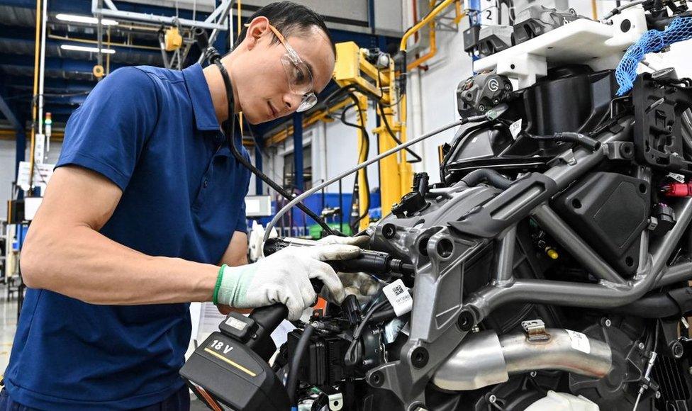 A worker assembles a motorbike at the Northstar Precision Vietnam factory in Vinh Phuoc province