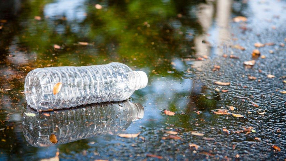 A discarded platic bottle in a street