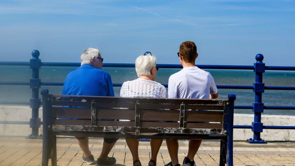 Family on a bench in Porthcawl