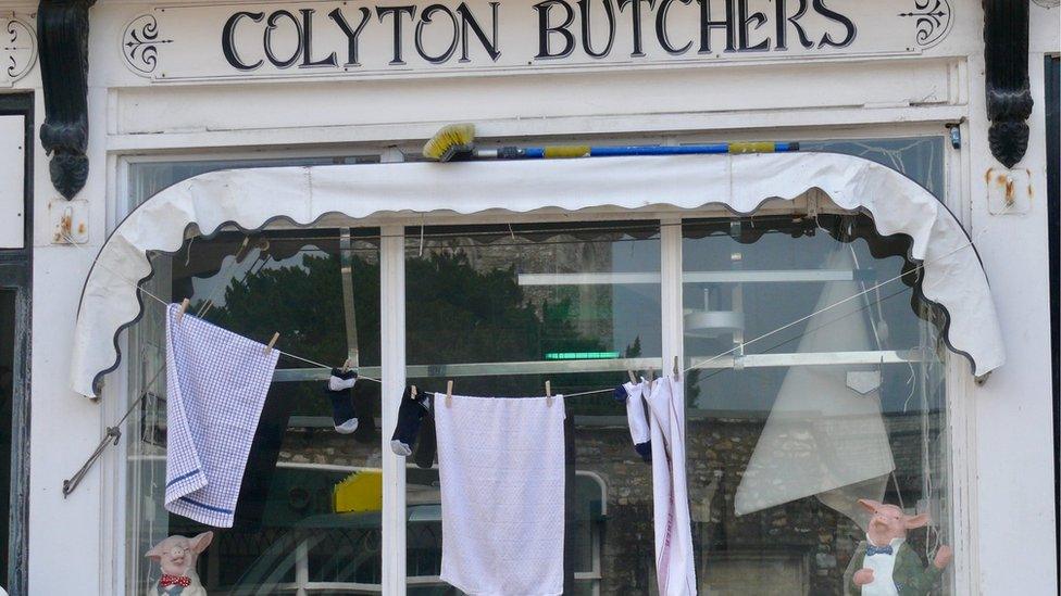 Washing hung up outside a butcher's shop in Colyton