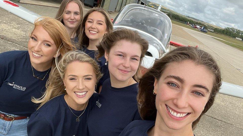 Katherine Moloney with five other women standing in front of an aircraft