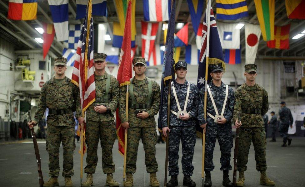 US and Australian navy personnel mark a joint military exercise on board a ship off the coast of Sydney in 2017.