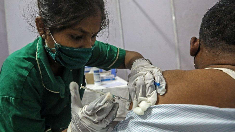 A man receives a shot of COVID-19 vaccine inside a vaccination centre in Mumbai, India, 12 April 2021.