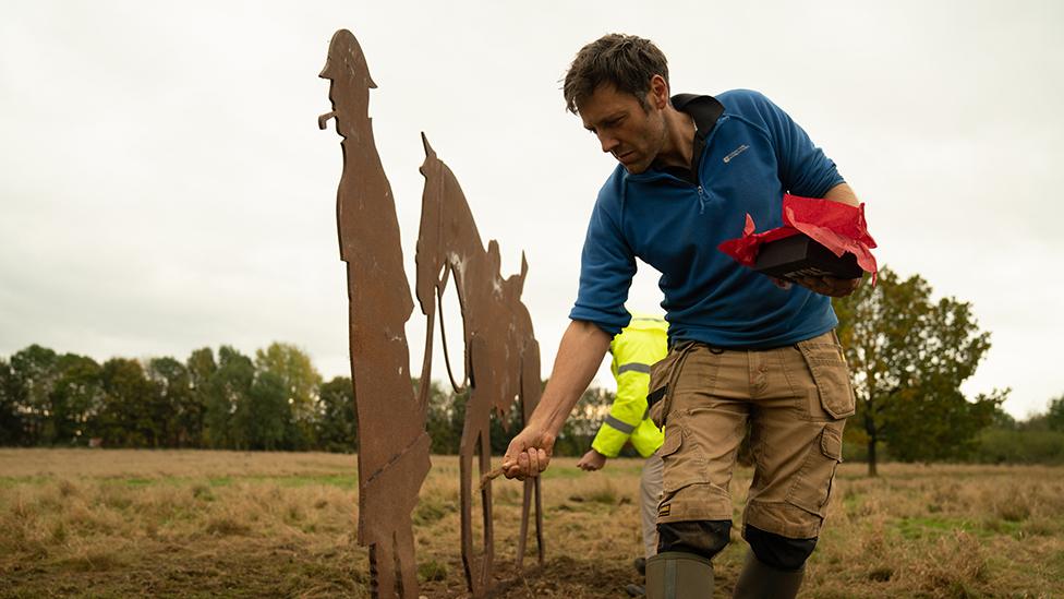 Man working on sculpture