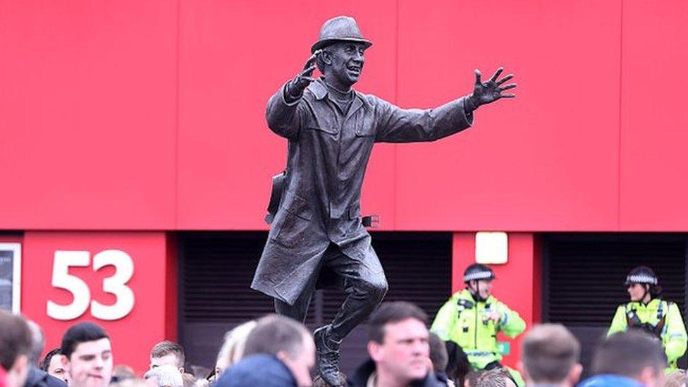 Fans gather around the statue