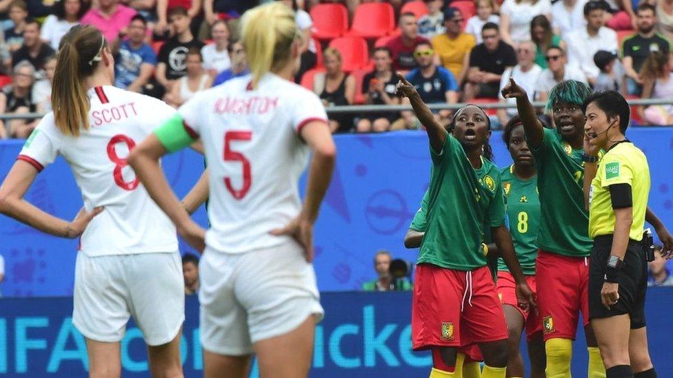 Cameroon players react to a VAR decision