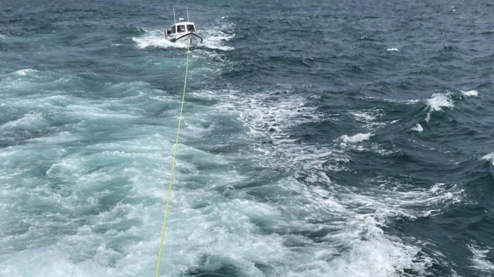 The boat being towed to shore