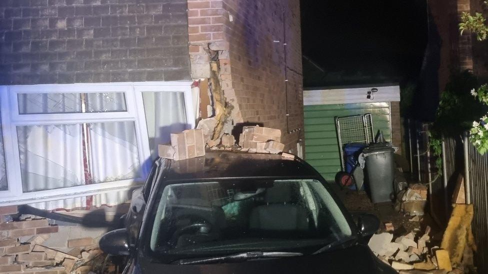 Car crashed into house