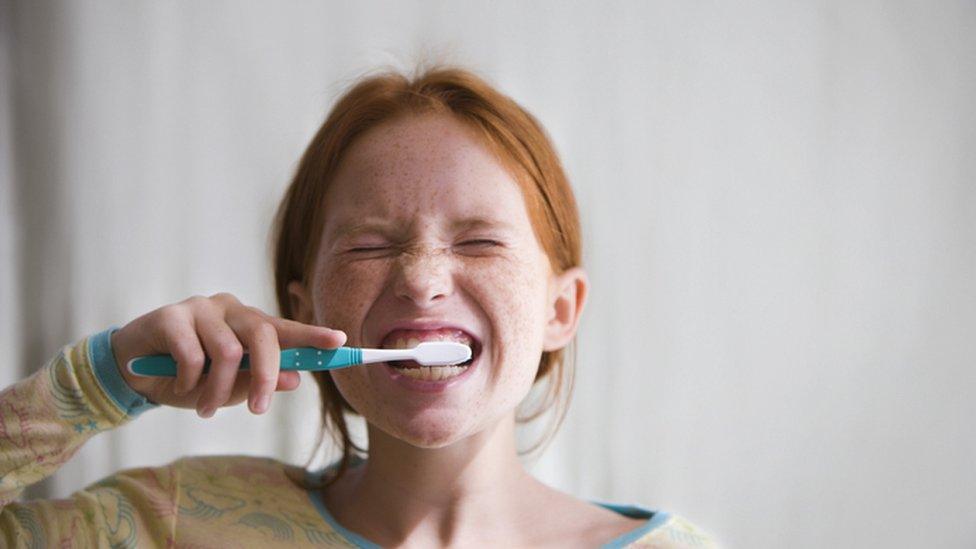 girl brushing teeth