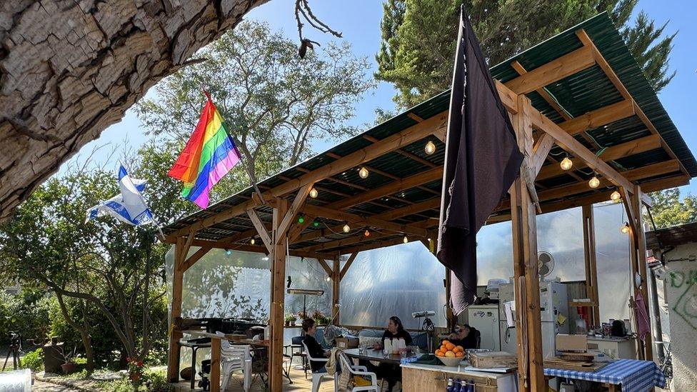 A black mourning flag hangs outside the house of Ayelet and Shahar