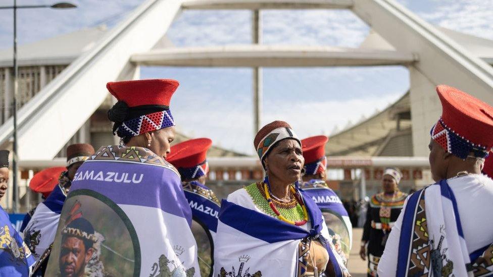 Zulu women clad in traditional dresses arrive at the Moses Mabhida Stadium