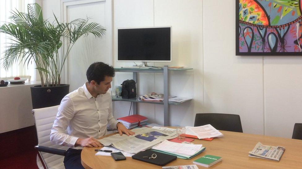 Mayor of Dieppe, Nicolas Langlois, reads a newspaper at his desk