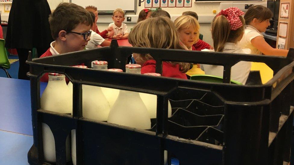 Pupils behind milk bottles