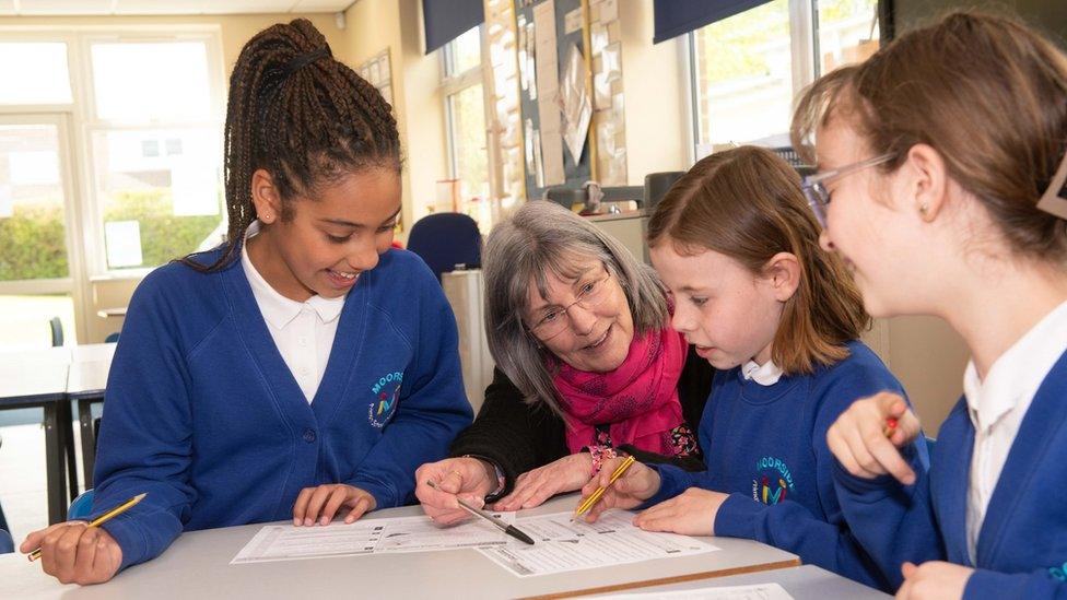 Teacher with pupils at Moorside Primary School and Nursery