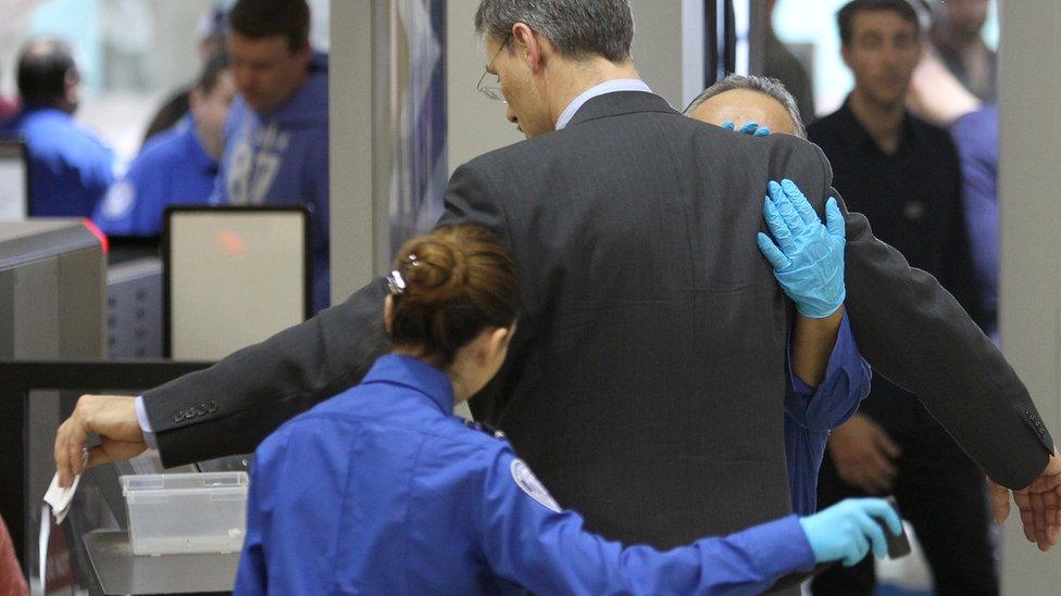 An air traveller is patted down after passing through a full-body scanner at Los Angeles International Airport in 2014