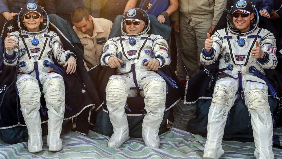 US astronauts Jack Fischer (R), Peggy Whitson (L) and Russian cosmonaut Fyodor Yurchikhin