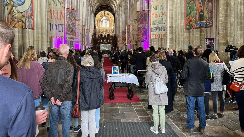 Interior of Winchester Cathedral full of people on the day of the Queen's funeral