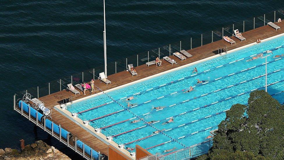 A pool next to a body of water