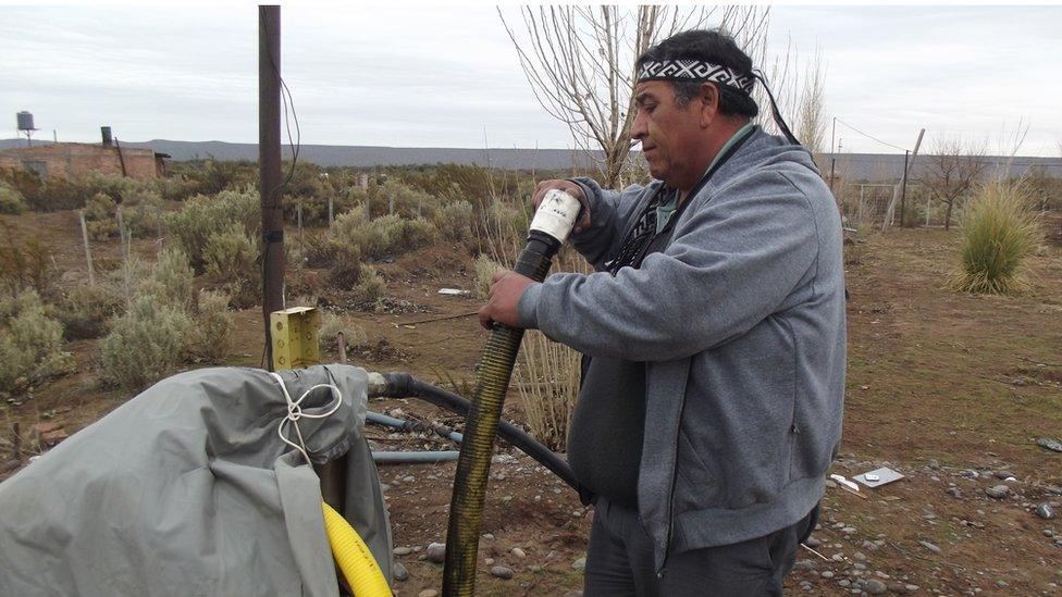 Albino Campo examines a greasy pipe