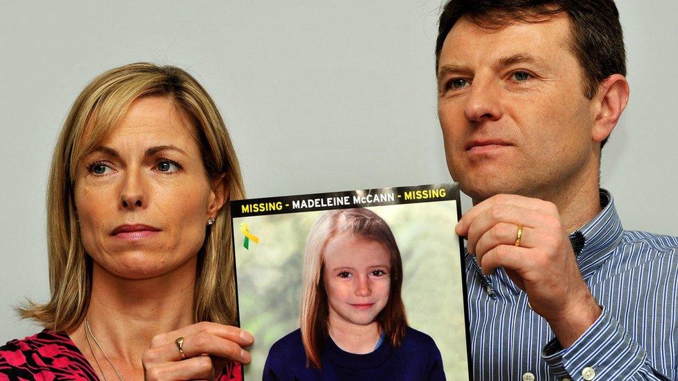 Kate and Gerry McCann with a photo of an older Madeleine McCann