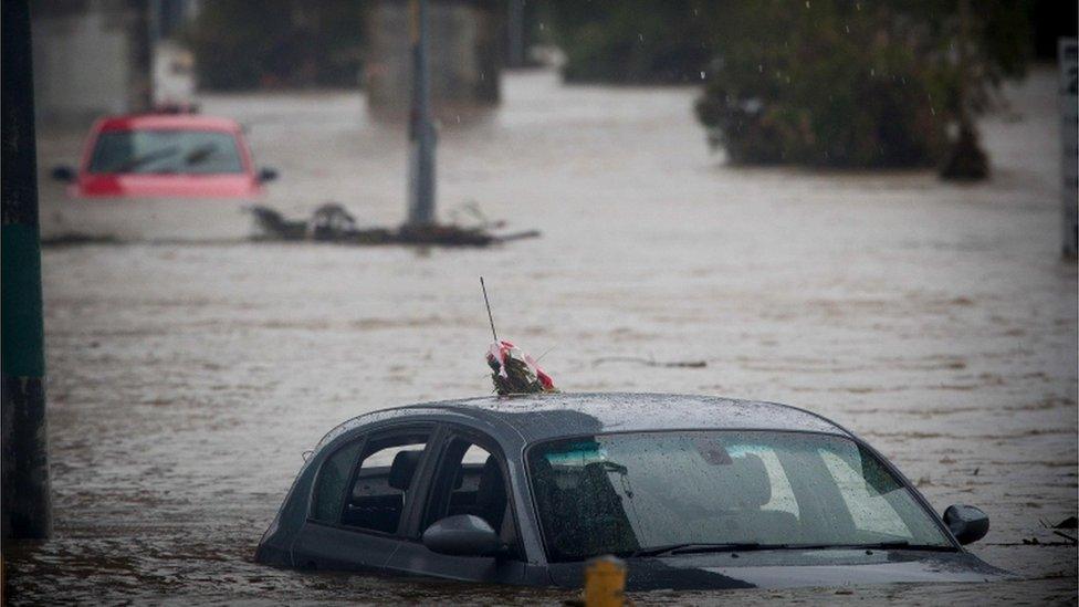 Submerged cars sit abandoned in a flooded car park in Toombul, in Queensland on 30 March 2017