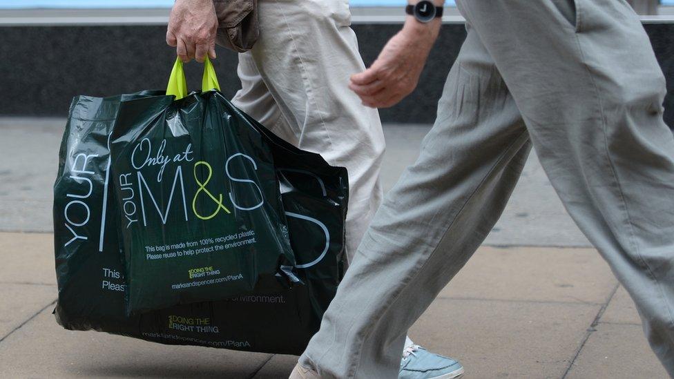 Person carrying a Marks and Spencer carrier bag