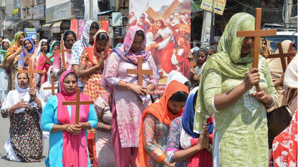 Indian Christian devotees carry wooden crosses in Amritsar