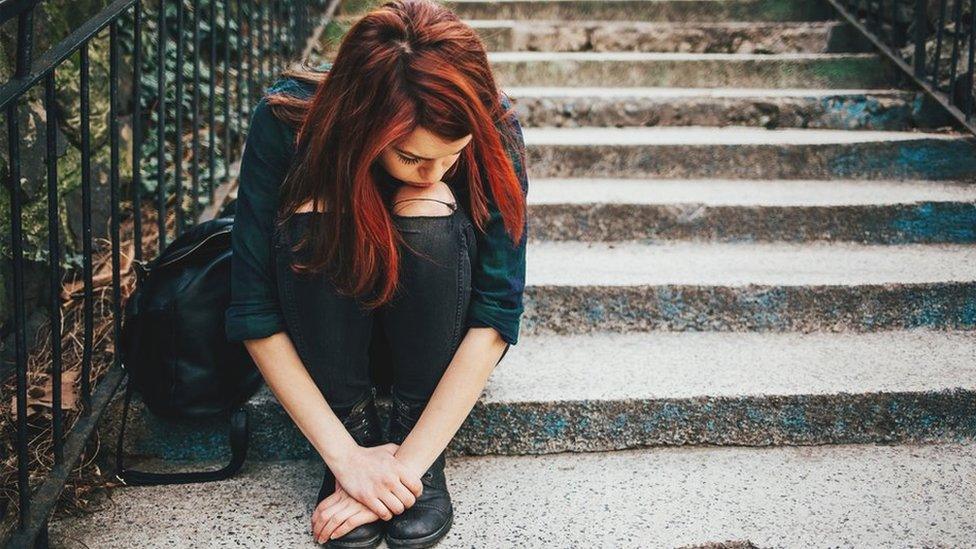 Teenage girl sitting on steps