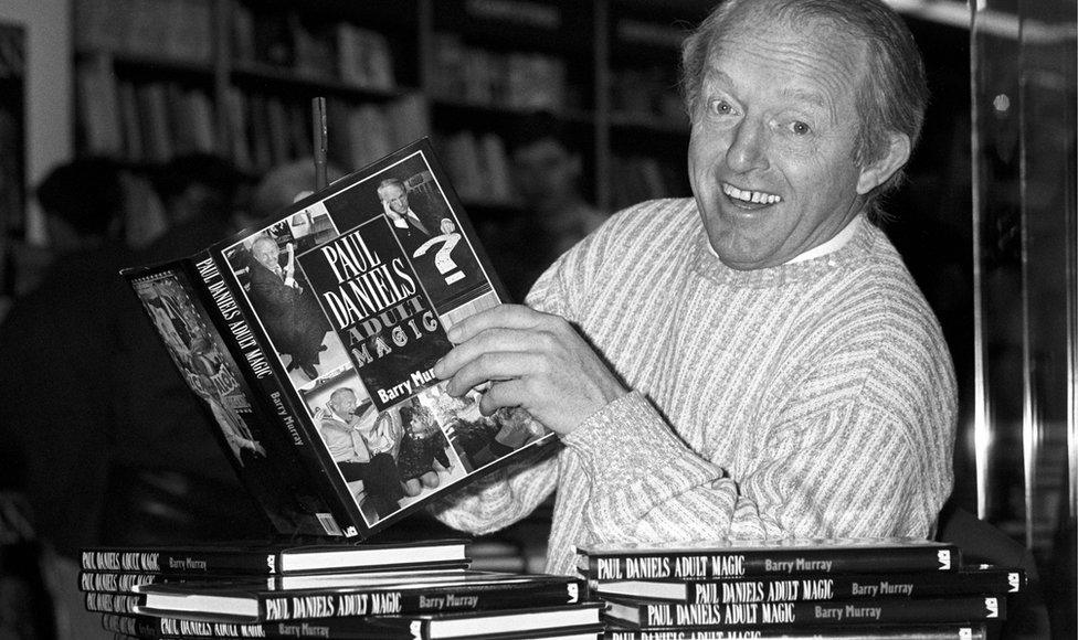 Paul Daniels with a copy of his book Adult Magic