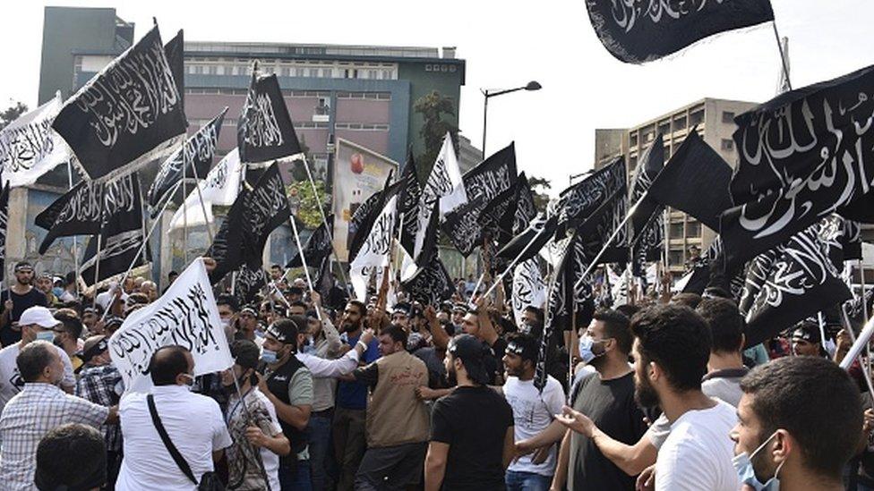 People carrying banners gather to protest in Lebanon