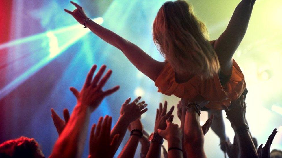 Woman crowd surfing