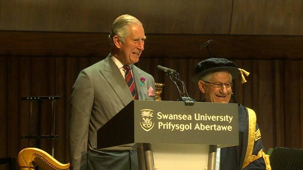 Prince Charles at a podium opening the campus