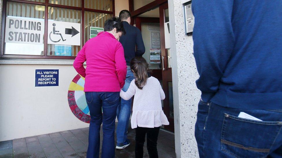 Woman and child heading in to vote