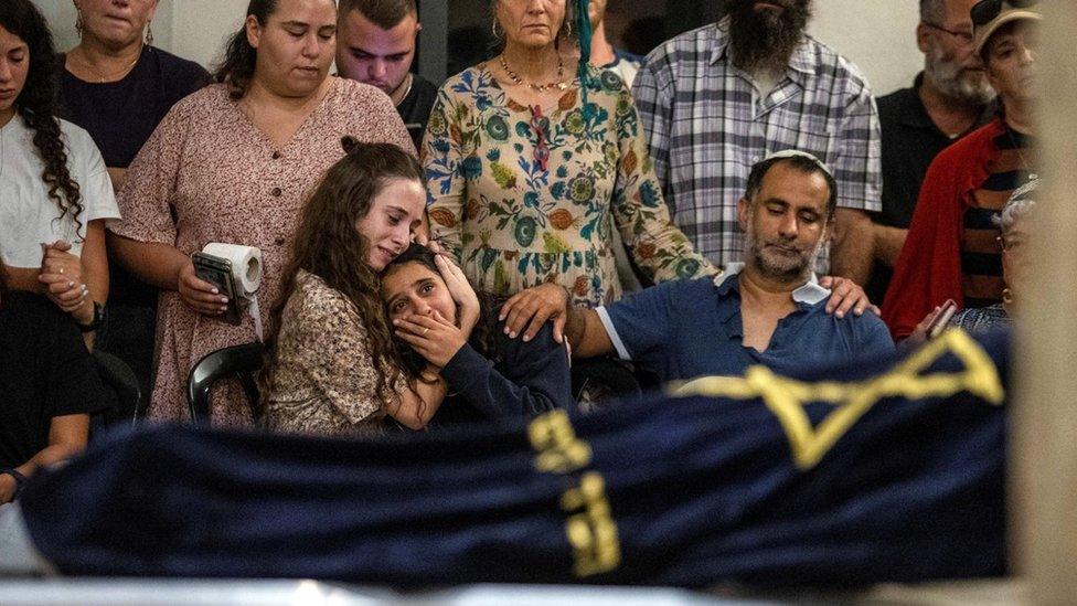 Friends and relatives mourn during the funeral of Batsheva Nigri, who was killed in a shooting attack on a car south of the city of Hebron, in in the occupied West Bank (21 August 2023)