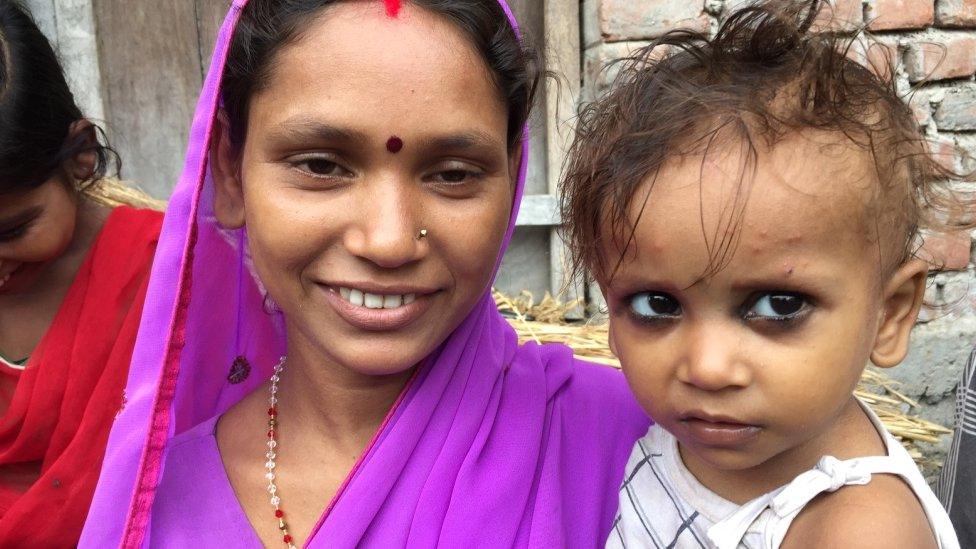 A Bihari woman holds her child