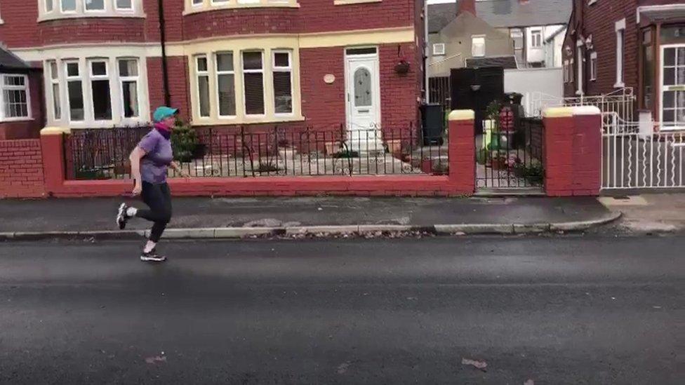 Cathryn Scott running alone in Cardiff