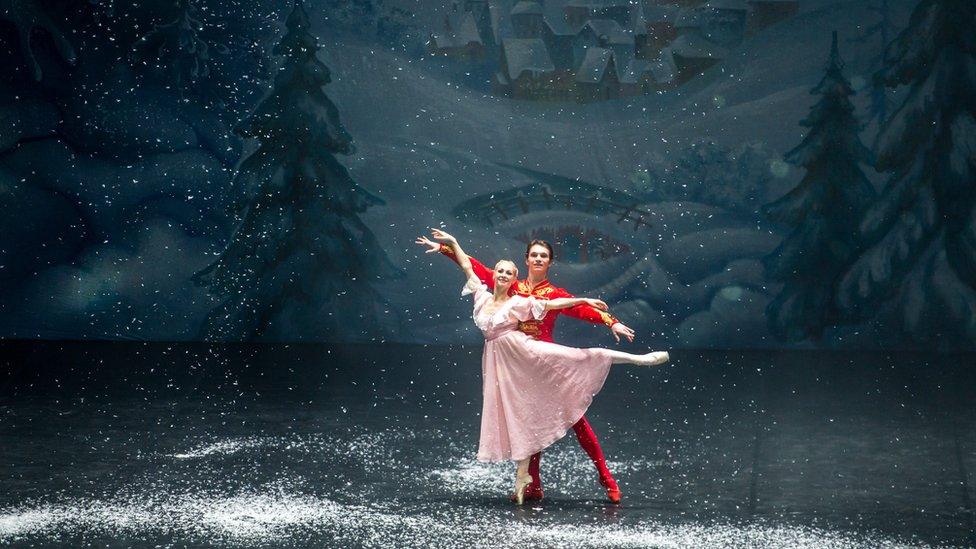 Two ballet dancers perform as the prince and Clara in The Nutcracker