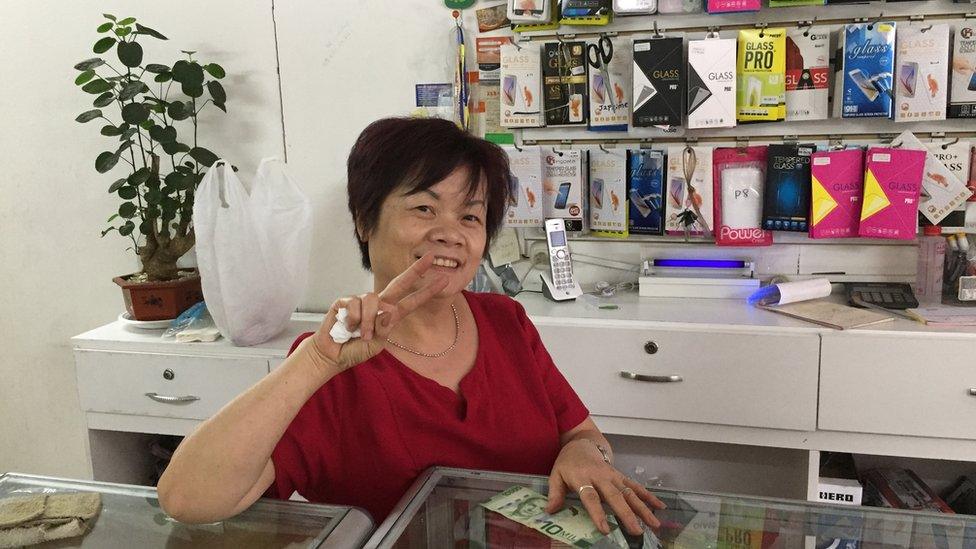 Li Zhong, originally from Canton, poses for a photo in her shop in San Jose, Costa Rica.