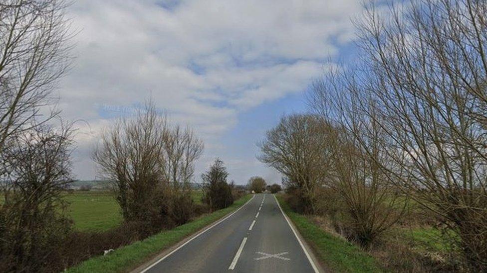 Google maps view of the A361 near Greylake in Somerset. Trees and fields can be seen either side of the road.