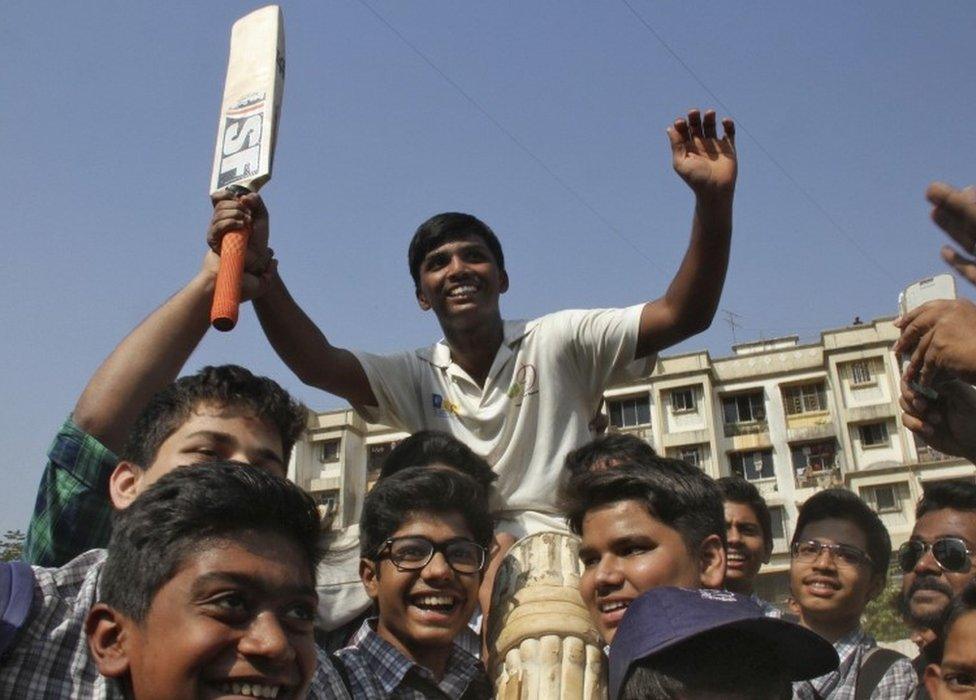 Schoolboy Pranav Dhanawade, 15, (C) is lifted by children as they celebrate during an inter-school cricket tournament in Mumbai, India, January 5, 2016.